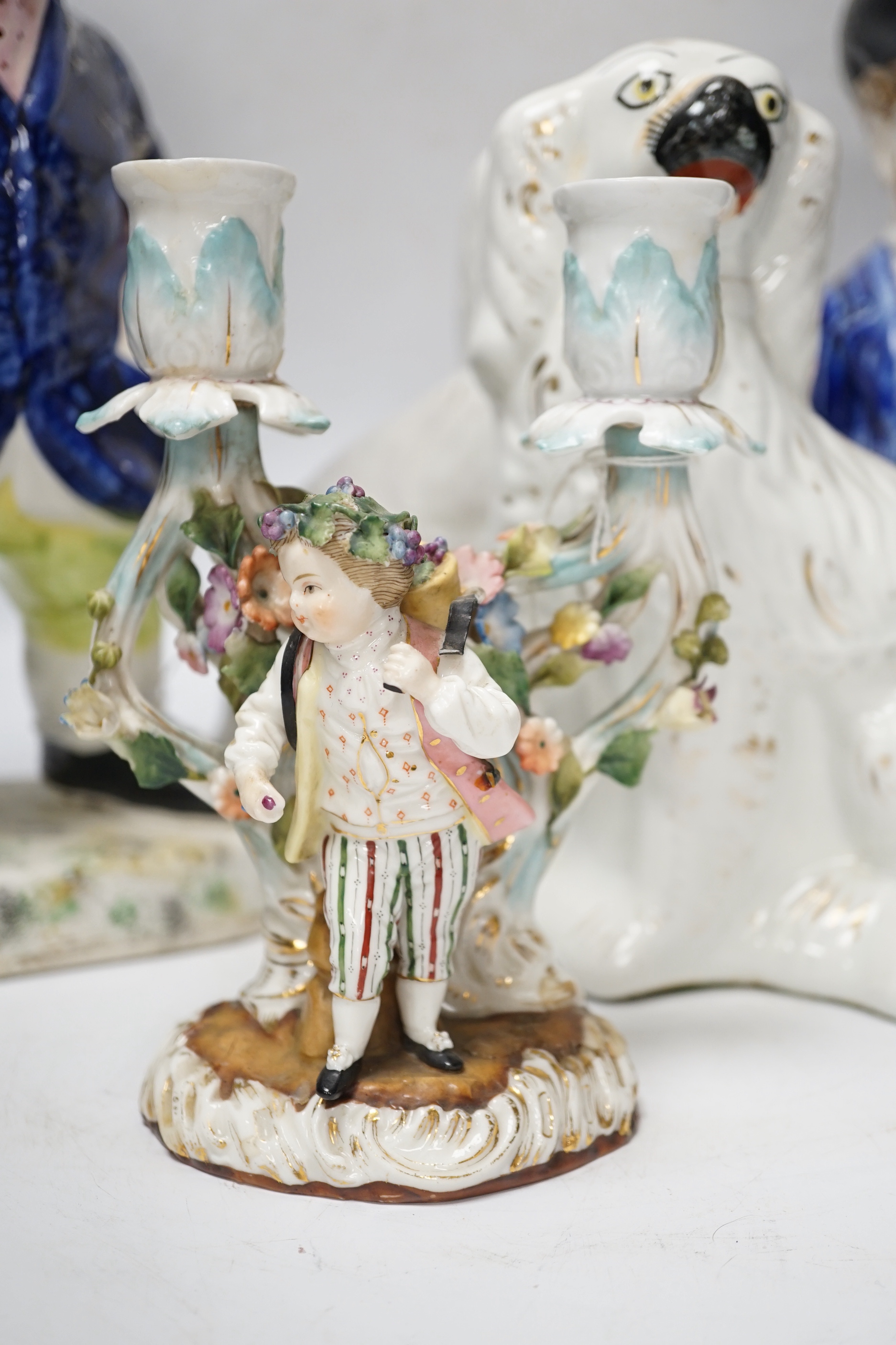 A pair of 19th century French figural two branch candelabra, 17cm high, together with two Staffordshire character jugs and a pair of Kings Charles Spaniel figures